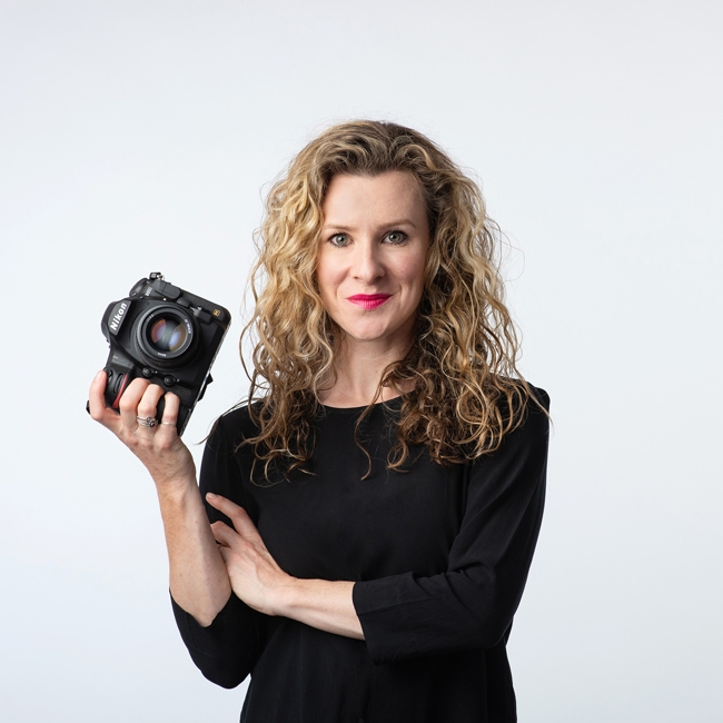 A photographer holding a camera